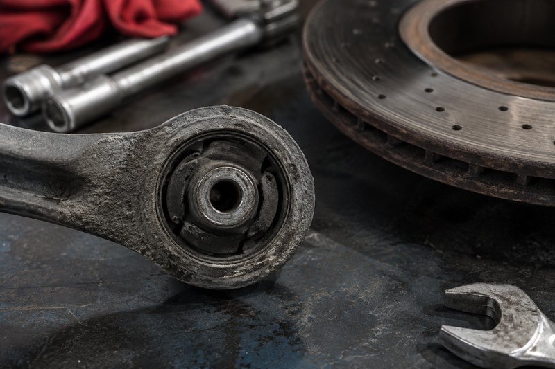 Used brake and suspension parts arranged on a mechanic bench